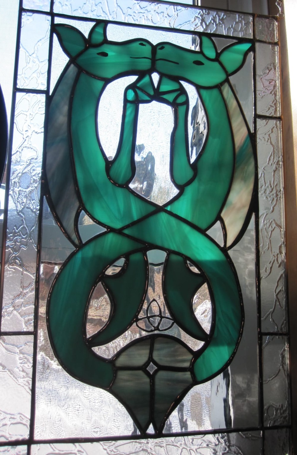 Green mirrored-animal stained-glass panel created by one of Paul's students