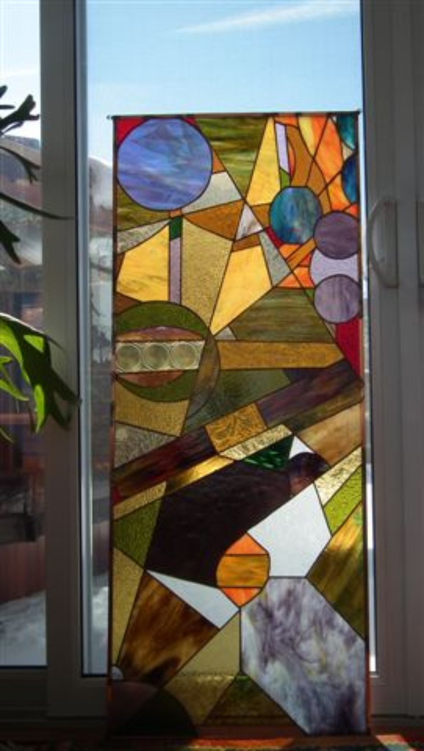 Tall geometric stained-glass panel created by one of Paul's students
